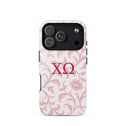 Chi Omega iPhone 17 Pro case with floral toile design in cardinal on white background and XO Greek letters, MagSafe compatible, glossy finish