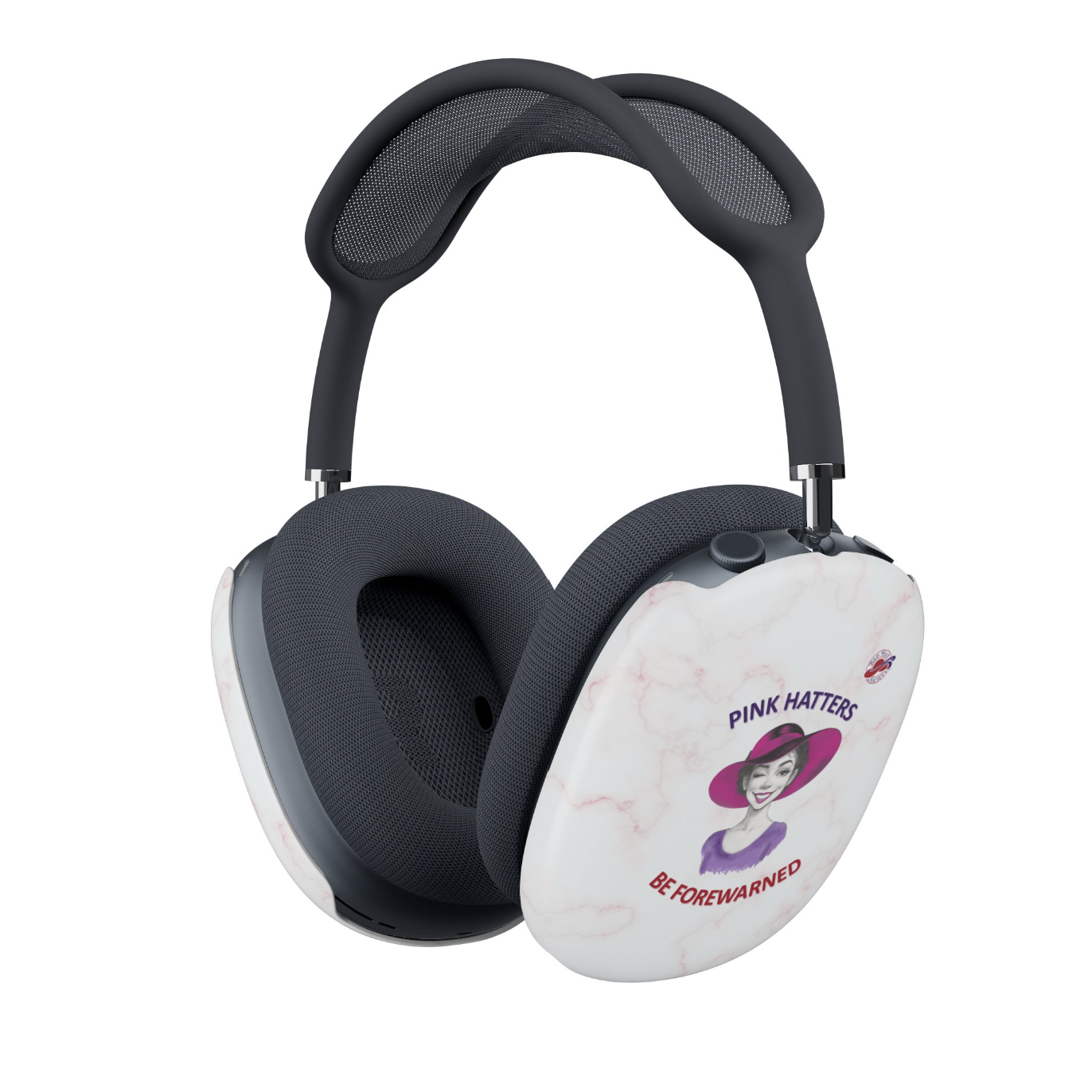 AirPods Max headphones with Covers in pink and white marble pattern on the outer cup, featuring a vintage-style illustration of a woman in a pink hat and the text 'PINK HATTERS BE FOREWARNED'. alongside the Red Hat Society Logo. The headband and ear cushions are dark blue mesh and fabric.