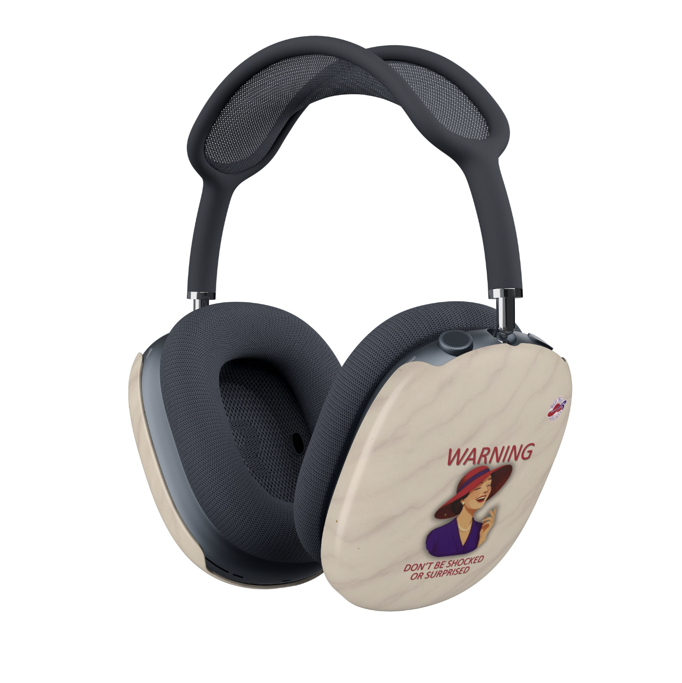 A pair of over-ear headphones with dark blue mesh and padding, featuring cream-colored outer covers with a vintage-style warning label graphic with a laughing woman in a red hat and the text 'WARNING DON'T BE SHOCKED OR SURPRISED', alongside the Red Hat Society Logo.