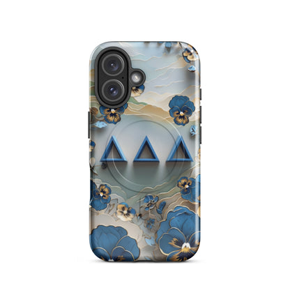 Tri Delta Origami Pansy MagSafe iPhone 16 case with bold ΔΔΔ Greek letters surrounded by origami pansy blossoms in blue, gold, and cream