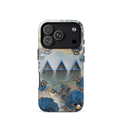 Tri Delta Origami Pansy MagSafe iPhone 17 Pro case with bold ΔΔΔ Greek letters surrounded by origami pansy blossoms in blue, gold, and cream