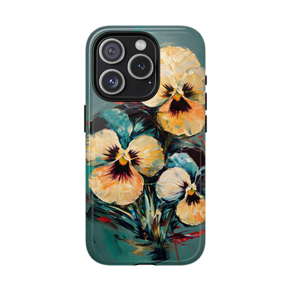 Golden Pansy Cascade floral iPhone 15 Pro MagSafe case featuring painterly yellow and cream pansy flowers with deep violet centers on a teal background.